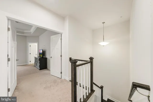 a spacious bedroom with a bed and a chandelier