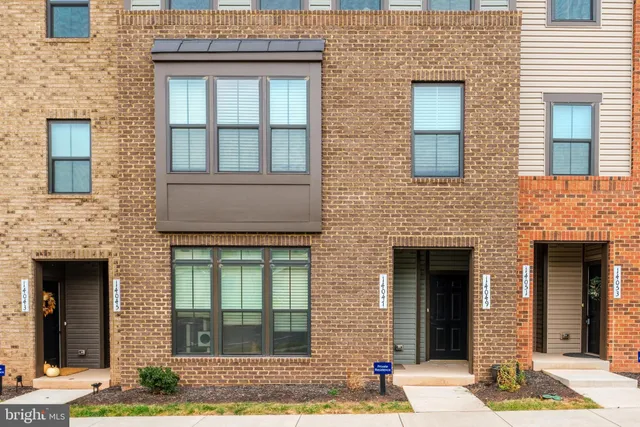 a front view of a brick house with many windows