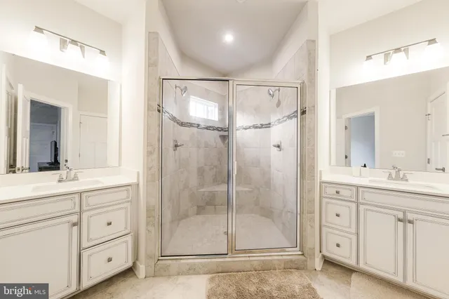 a spacious bathroom with a shower and a glass door