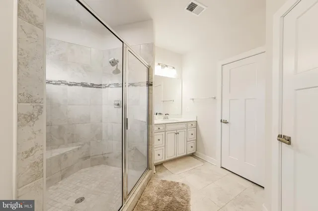 a bathroom with a shower sink and mirror