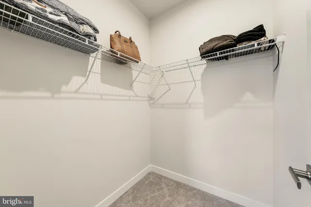 a spacious bathroom with a mirror and a toilet