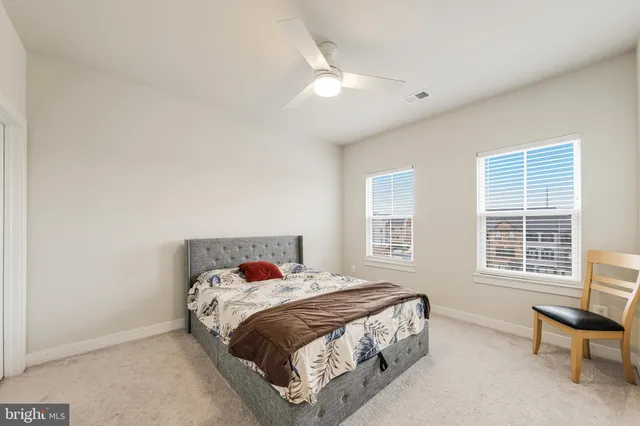 a bedroom with a bed and a chair