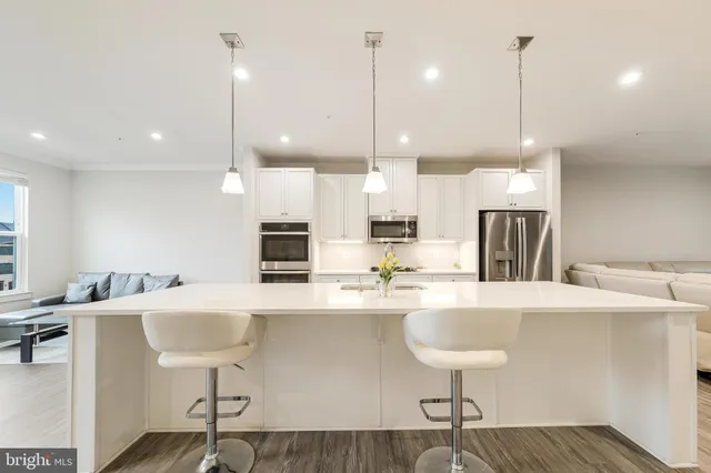 a large kitchen with a table and chairs
