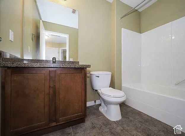 13548 South Villa Rosa Way Draper, UT 84020 - Photo 16 of 28 Wood-finish vanity with a stone-finish countertop, full-width mirror, white toilet, and a white tub with shower surround