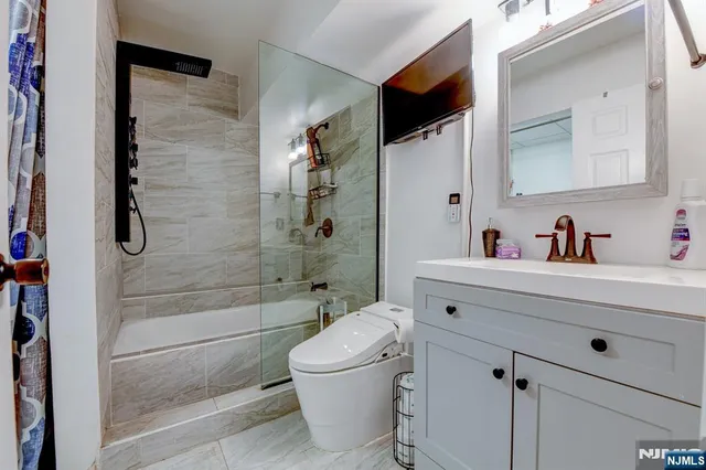 a bathroom with a sink toilet and shower
