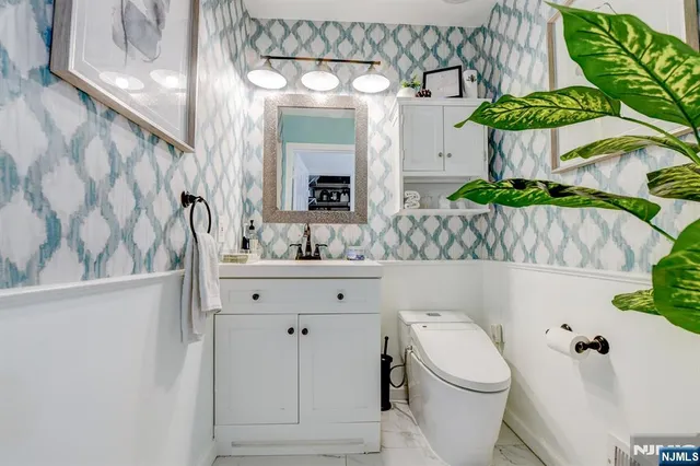 a bedroom with bed and the view of bathroom