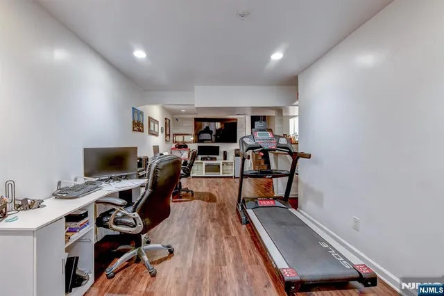 a living room with furniture and a book shelf