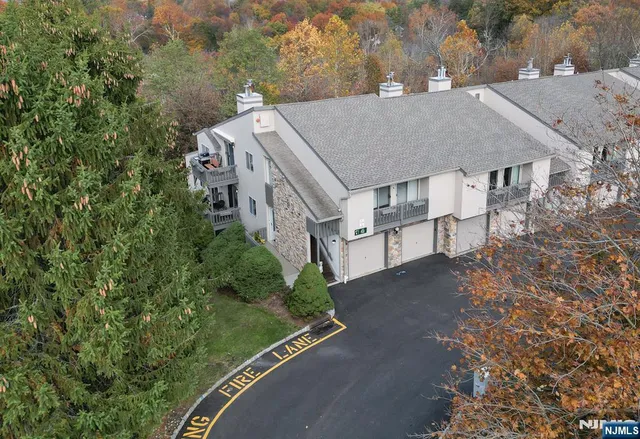 an aerial view of multiple houses with yard