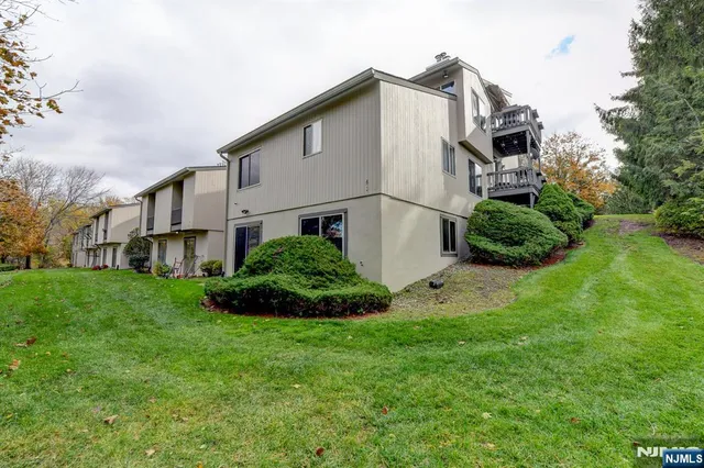 a white house with green field in front of it