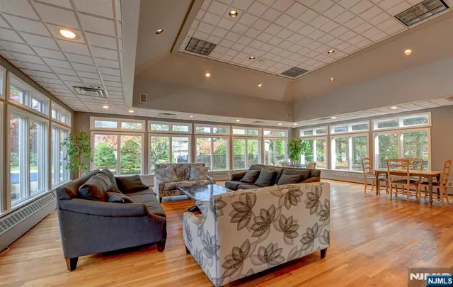 a living room with furniture and large windows