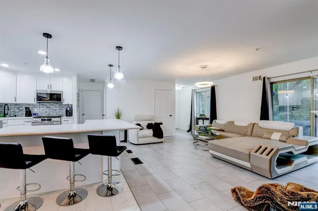 a living room with furniture and kitchen view