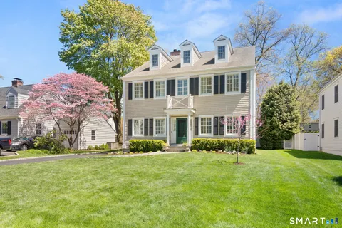 a front view of house with yard and green space
