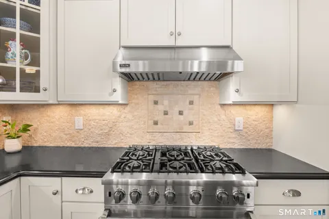 a stove top oven sitting inside of a kitchen