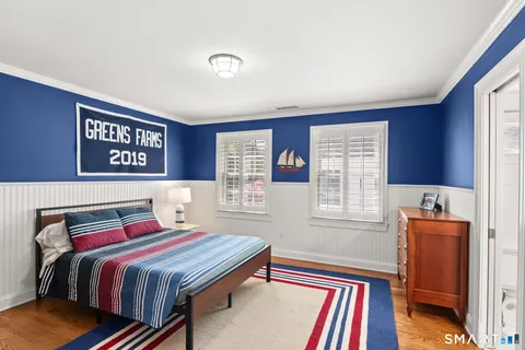 a bedroom with a bed and a lamp next to a window