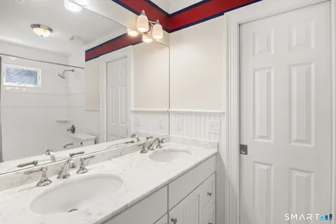 a bathroom with a double vanity sink and a mirror