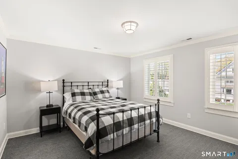a bedroom with a bed and a night stand