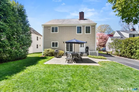 a front view of house with yard and outdoor seating
