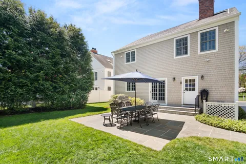 a view of a house with backyard and sitting area