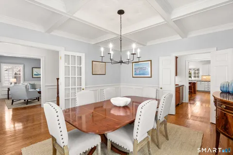 a view of a dining room with furniture wooden floor and chandelier