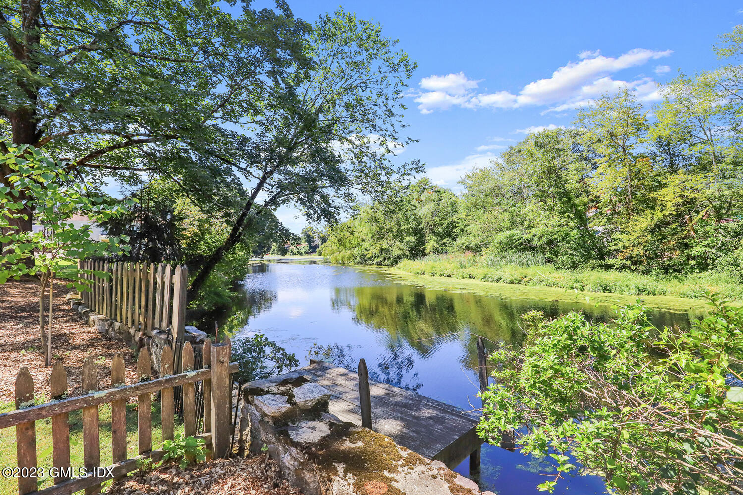 220 Sheep Hill Road, Unit 2 Riverside, CT 06878 - Photo 16 of 20 a view of a lake with a garden