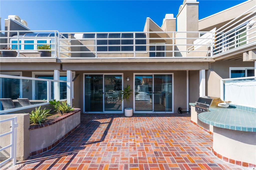 3310 Tempe Drive Huntington Beach, CA 92649 - Photo 13 of 52 Large waterfront patio with built in grill and bar space.