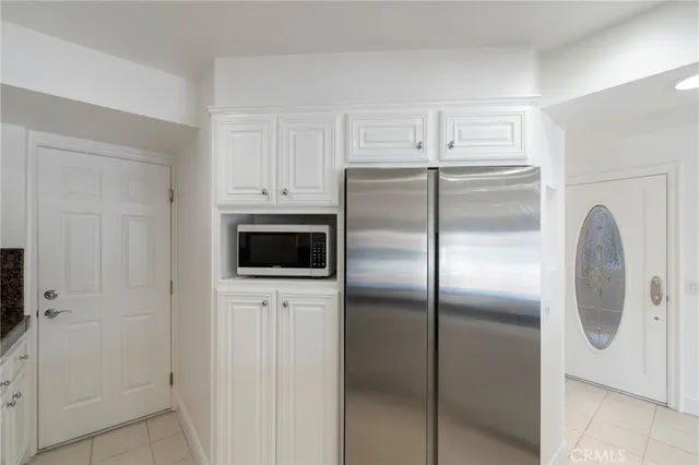 a view of empty room with window and cabinet