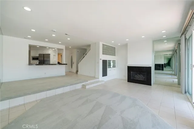 a view of an empty room with a fireplace