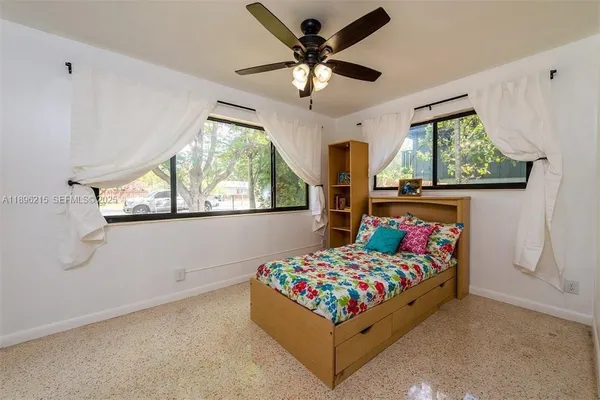 a bedroom with bed and a window