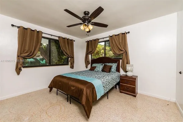 a bedroom with a bed and window