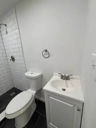a white toilet sitting next to a bathroom sink