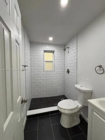 a bathroom with a toilet a sink and shower
