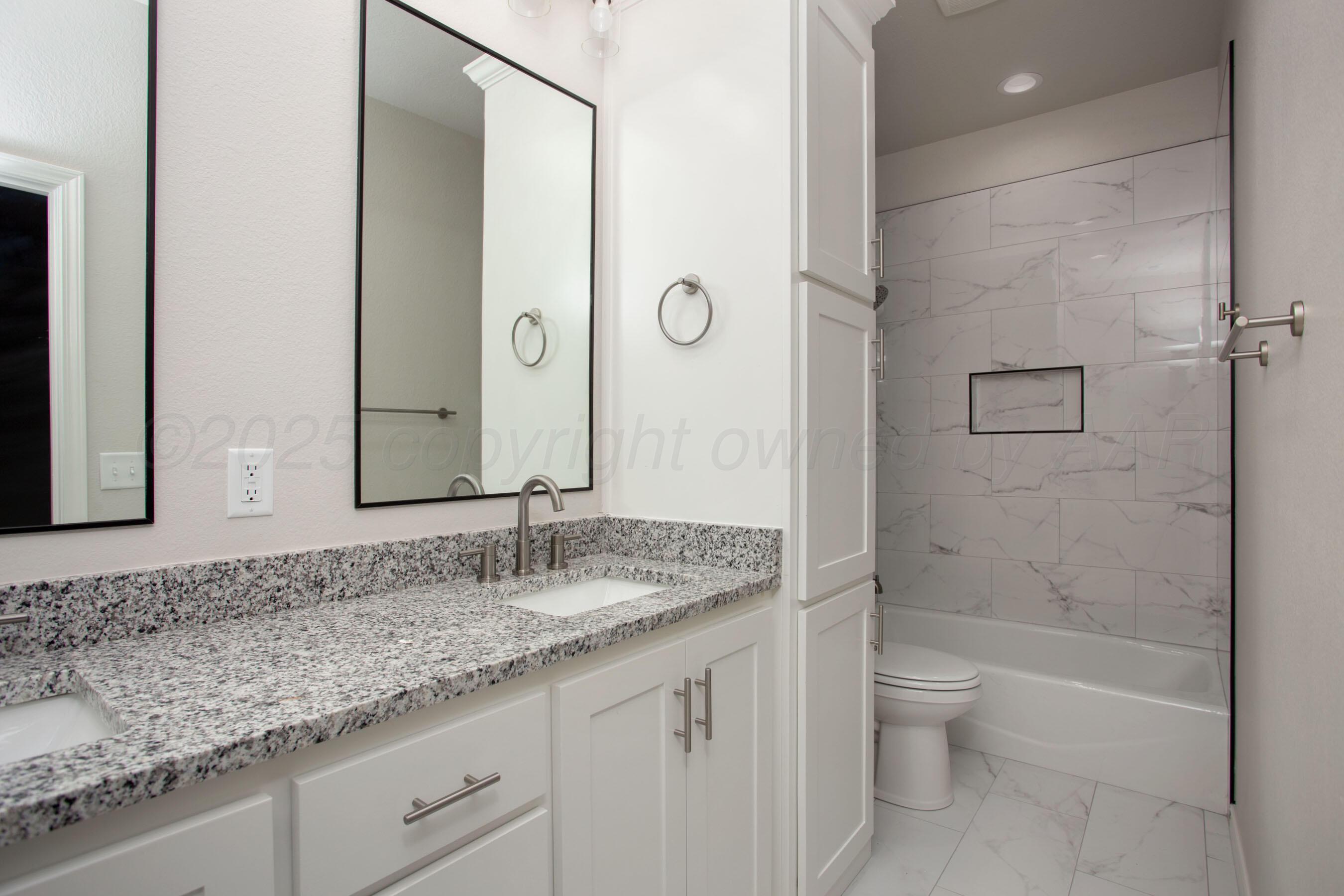22131 Howard Draw Rd Canyon Canyon, TX 79015 - Photo 11 of 25 a bathroom with a granite countertop sink a toilet and shower