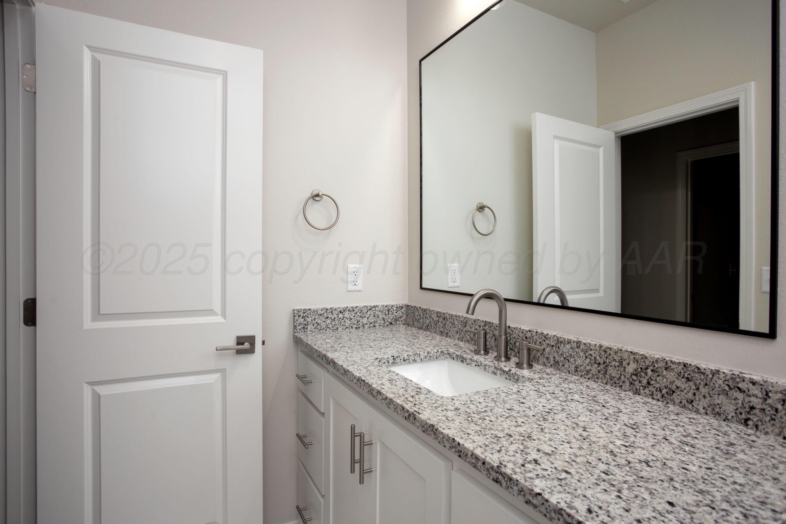 22131 Howard Draw Rd Canyon Canyon, TX 79015 - Photo 14 of 25 a bathroom with a granite countertop sink and a mirror