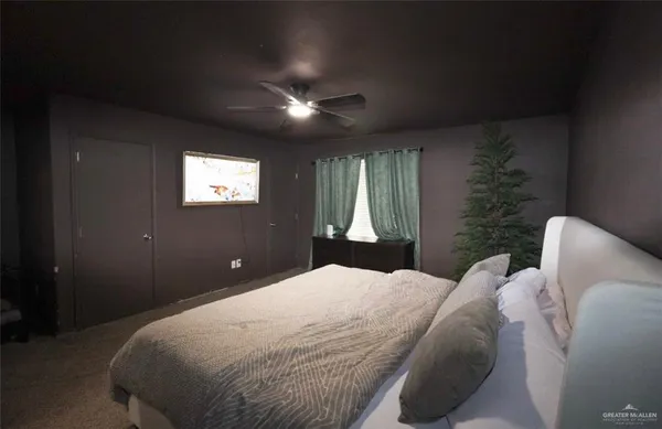 a bedroom with a large bed and a window