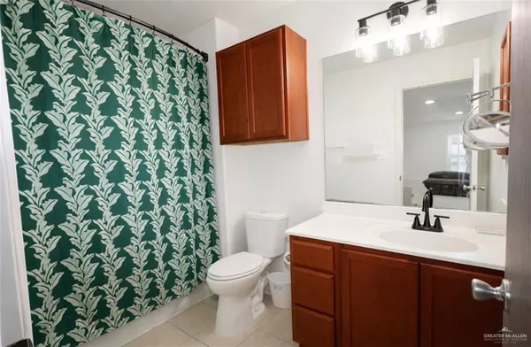 a bathroom with a sink toilet and mirror