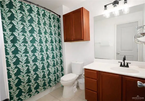 a bathroom with a sink a toilet and mirror