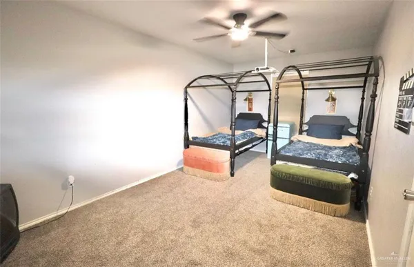 a bedroom with chandelier fan and wooden floor