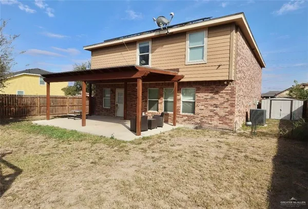 a view of a house with a yard and wooden fence