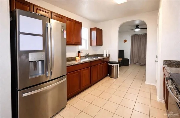 a kitchen with stainless steel appliances a sink stove and cabinets