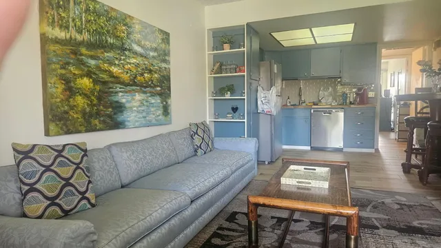 a living room with furniture and a floor to ceiling window