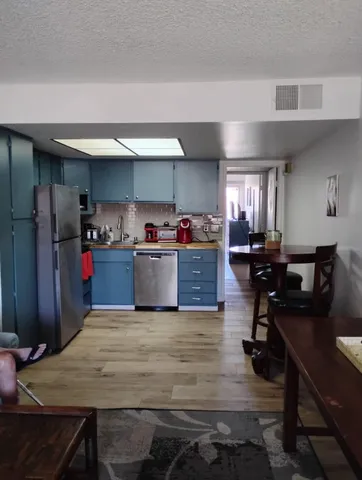 a kitchen with kitchen island a cabinets counter top space a sink and appliances