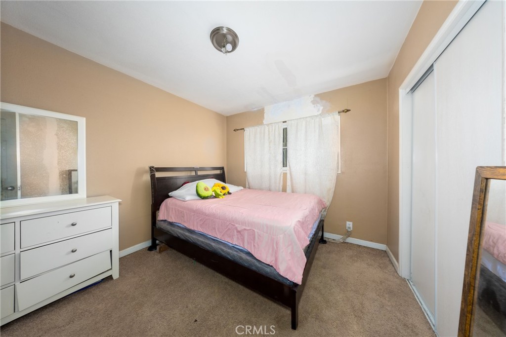 566 South Sage Avenue Rialto, CA 92376 - Photo 21 of 28 a bedroom with a bed and a dresser