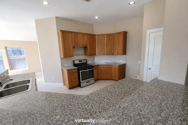 a kitchen with stainless steel appliances a refrigerator and a stove top oven
