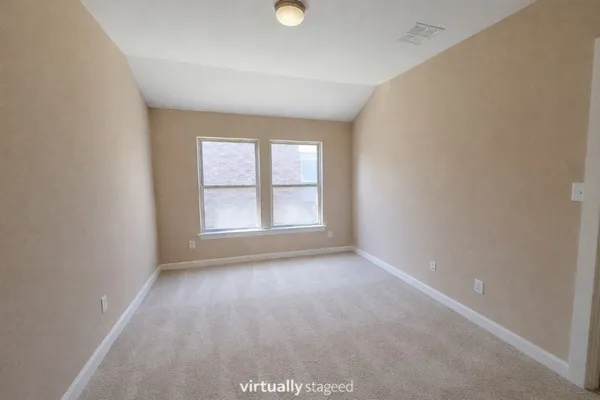 an empty room with windows and mirror