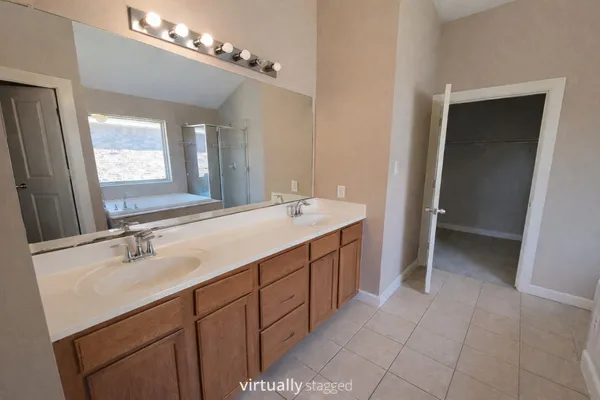 a bathroom with a sink double vanity and a mirror