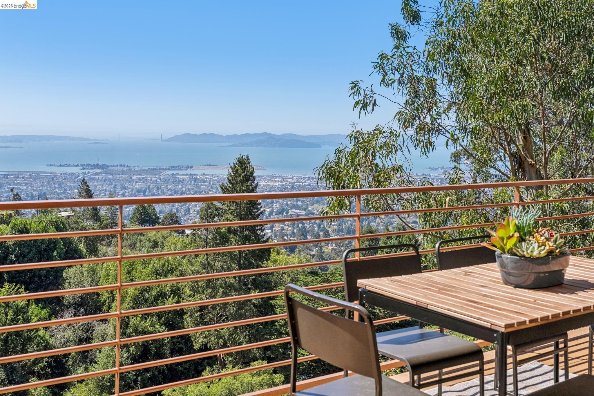 1394 Queens Road Berkeley, CA 94708 - Photo 19 of 63 Expansive outdoor deck with a metal railing overlooking the bay and urban landscape