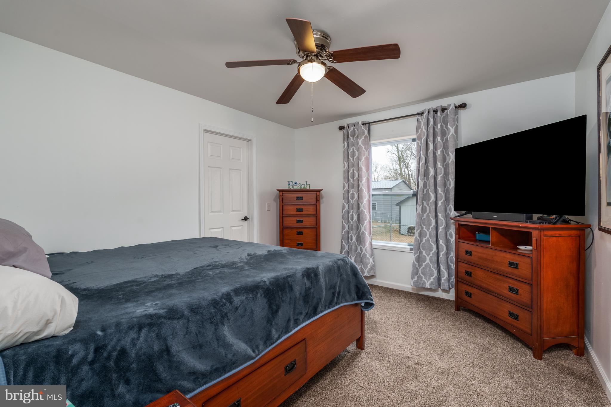 158 Main Street Hartly, DE 19953 - Photo 17 of 31 a bedroom with a bed and a flat screen tv