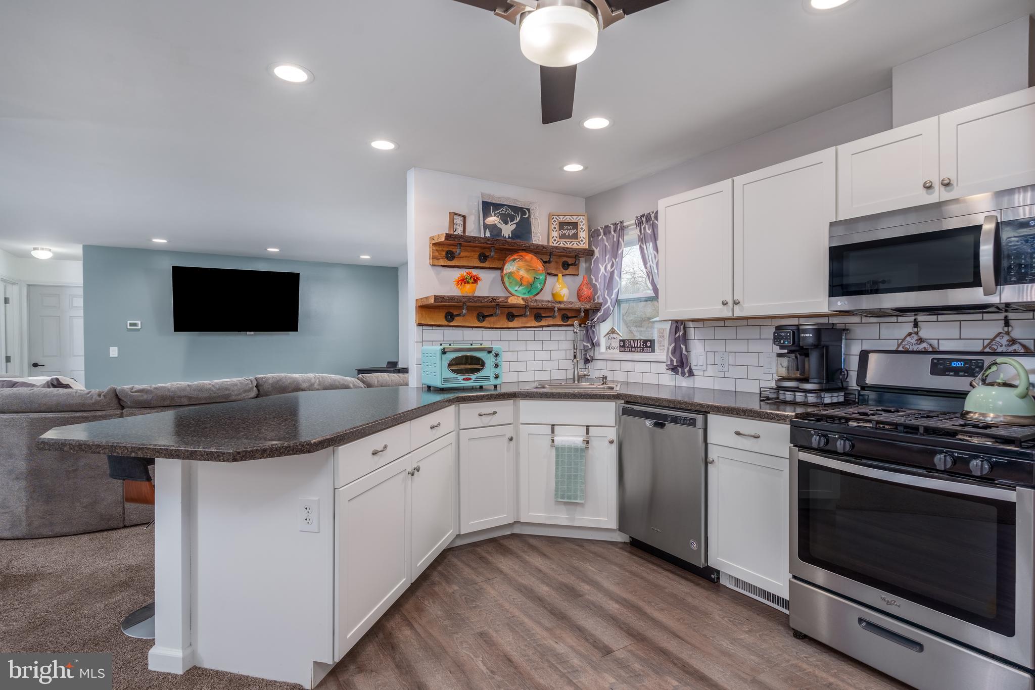 158 Main Street Hartly, DE 19953 - Photo 10 of 31 a kitchen with stainless steel appliances granite countertop a sink and a stove