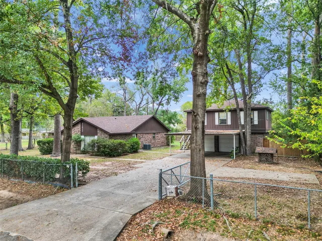 an aerial view of a house with a garden and lake view