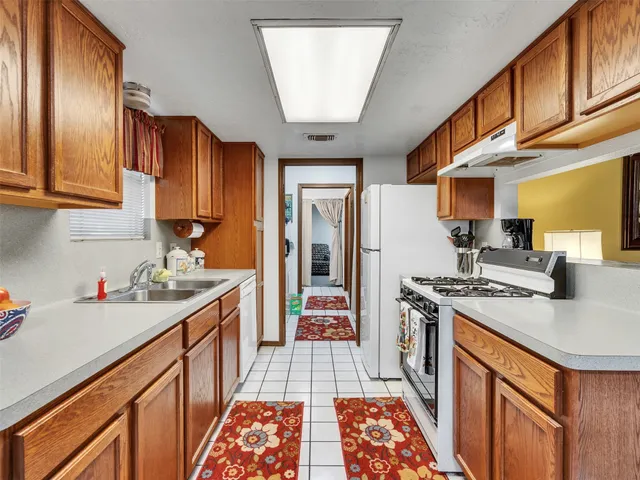a kitchen with stainless steel appliances granite countertop a sink stove and cabinets